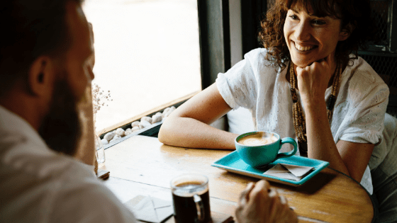 a couple talking in a cafe