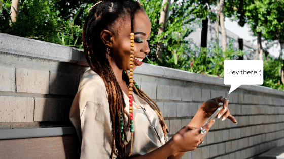 an african woman texting