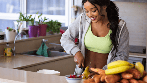 an african woman chopping vegetables